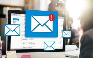 An email icon signaling a full inbox in front of a computer screen.