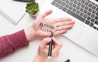 A person writing the insecure password "123456" on their hand in sharpie.