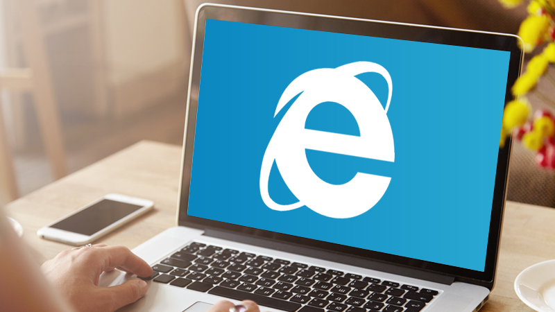 A laptop showing a large Internet Explorer logo.