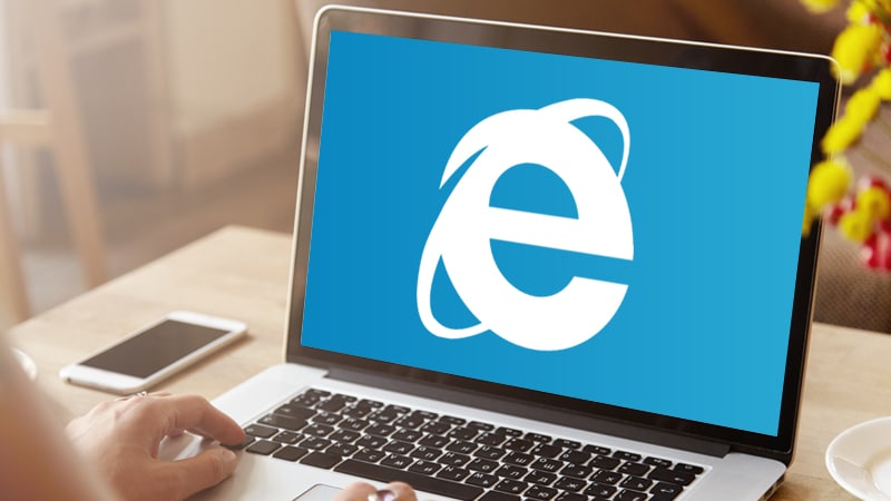 A laptop showing a large Internet Explorer logo.