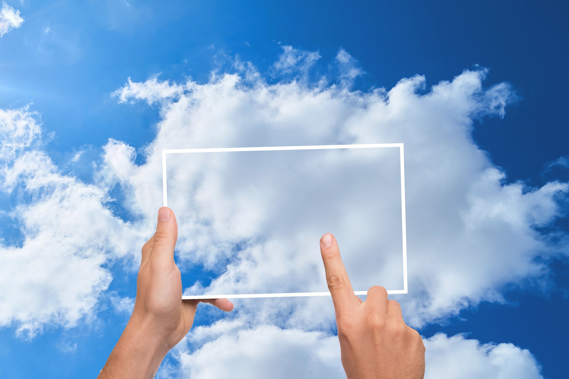 Cloud Computing concept - person holding a hollow rectangle up at the clouds like a tablet IT, backup, and cloud computing in Modesto CA