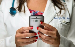 Close-up of a doctor using a smartphone
