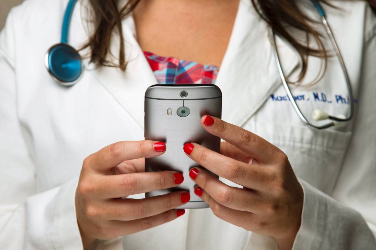 Close-up of a doctor using a smartphone Cybersecurity Risk Assessment Audits in Modesto CA from your trusted IT Security Services Department at NBIT