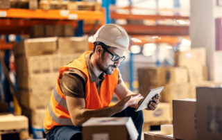 An employee checking their warehouse cybersecurity settings from their tablet.