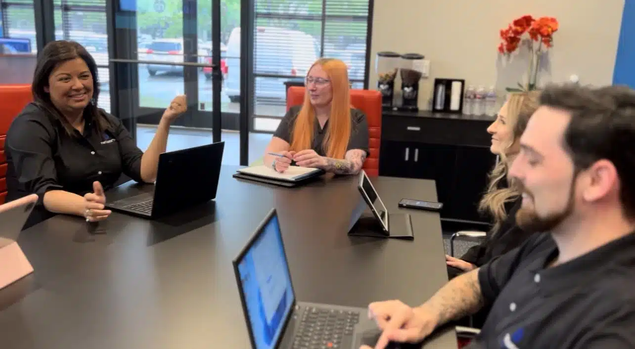 Network Builders IT Modesto team sitting at a table discussing managed IT options and cybersecurity strategies.